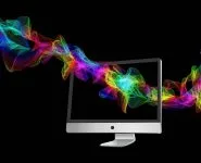 colorful particles and computer screen on black background
